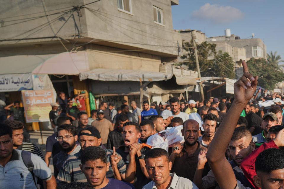 Mourners carry bodies of Palestinians killed by Israeli fire (Abdel Kareem Hana/AP)