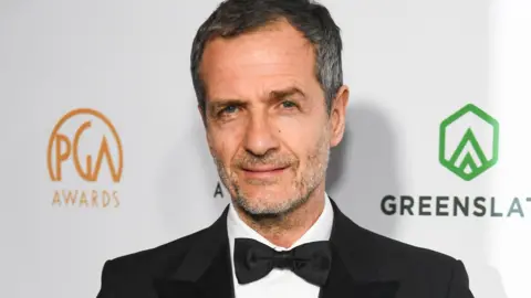 Getty Images David Heyman in a black dinner jacket and black bow-tie