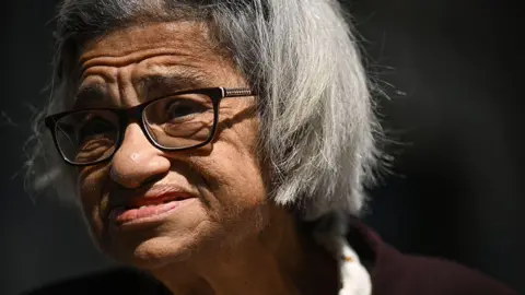 Getty Images Laila Soueif, mother of jailed British-Egyptian activist Alaa Abdel Fattah, reacts as she makes a statement about her son's situation and her own hunger strike, outside the gates of Downing Street in central London on May 20, 2025. 