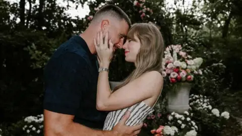 Instagram/Reuters A screenshot taken from Instagram showing Travis Kelce and Taylor Swift hug each other