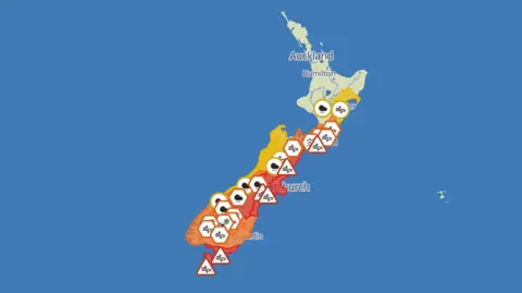 MetService A map of New Zealand, with most of its South Island coloured orange and red and covered with multiple wind and rain symbols