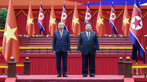 Getty Images Vietnam's Communist Party chief To Lam (left) posing for a photo with Kim Jong Un (right) during a welcoming ceremony as part of his three-day official visit in North Korea, where he will also attend celebrations marking the Workers' Party's 80th anniversary