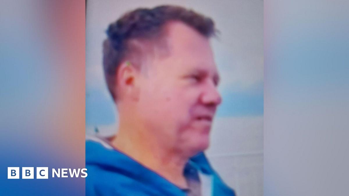 Matthias Beutin looking off camera. He has short dark hair and is wearing a blue jacket.