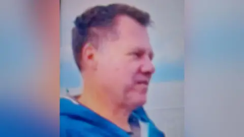 Police Scotland Matthias Beutin looking off camera. He has short dark hair and is wearing a blue jacket.