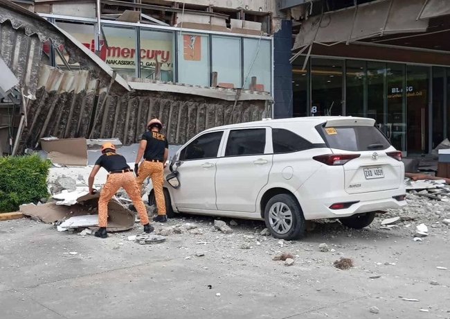 Fire officers removing debris outside a shopping mall following an earthquake in Butuan city, Caraga region, Philippines, 10 October 2025.