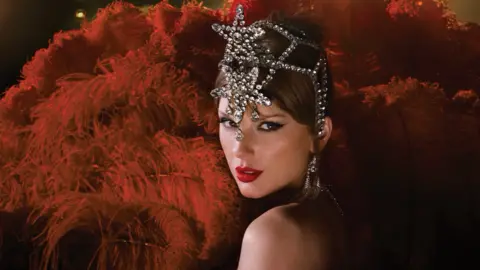 TAS Rights Management Taylor Swift with red feathers as part of a showgirl costume