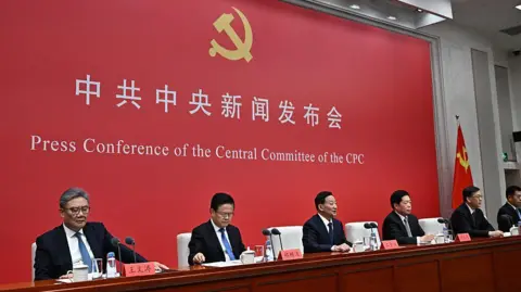 Getty Images Six Chinese officials hosting a press conference regarding the results of a four-day meeting of communist party officials