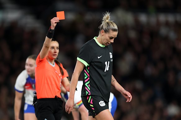 The referee shows Alanna Kennedy a red card during a friendly against England on October 28.