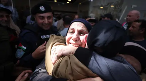 EPA A woman hugs a freed prisoners. 