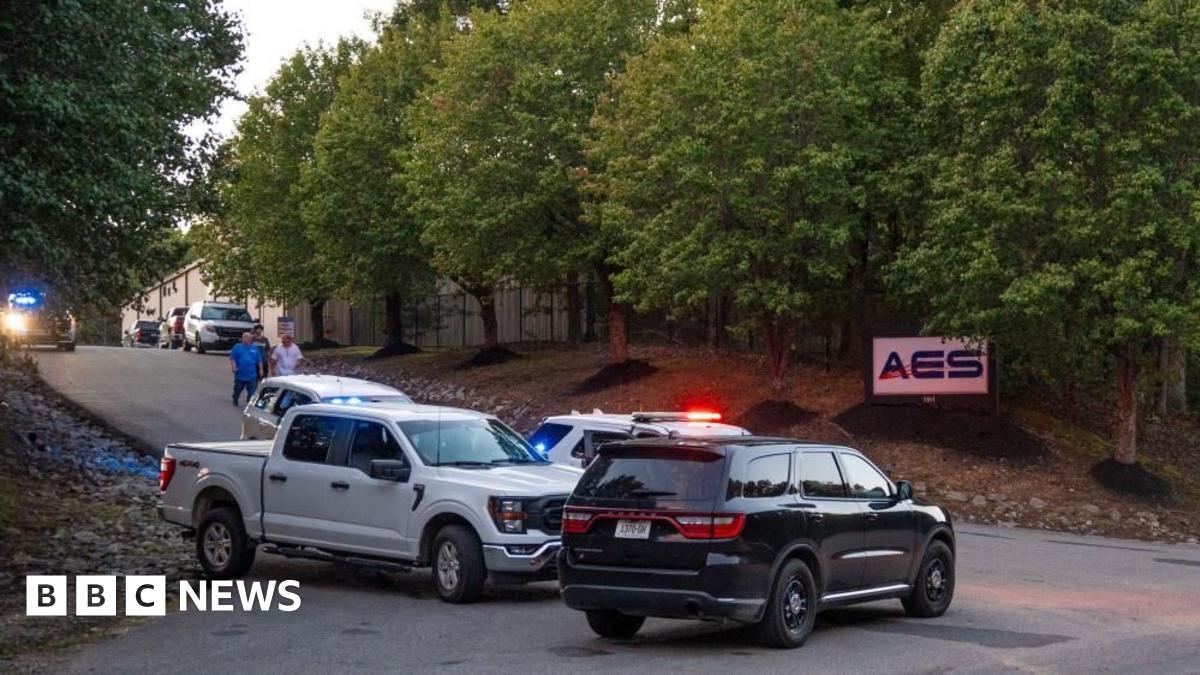 Police cars parked out front of the plant