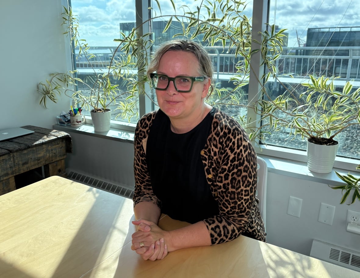 A woman sits in an office.