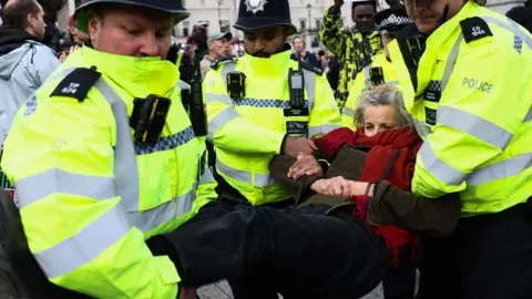Reuters Police officers detain a protester during a mass demonstration organised by Defend our Juries