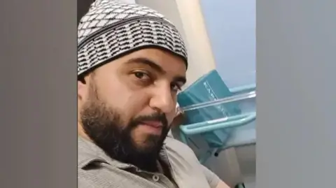Facebook Jihad Al-Shamie shown with a beard and a hat, looking at the camera in an apparent selfie taken from Facebook