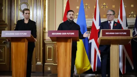 EPA/Shutterstock From left to right: Danish Prime Minister Mette Frederiksen, Ukraine's President Volodymyr Zelensky and UK Prime Minister Sir Keir Starmer speak at a press conference in London. Photo: 24 October 2025
