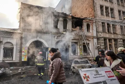 EPA/Shutterstock Ukrainian rescuers work at the site of a Russian air strike on a kindergarten in Kharkiv, north-eastern Ukraine. Photo: 22 October 2025