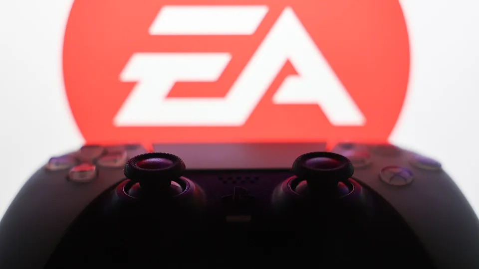 Electronic Arts logo displayed on a laptop screen and DualSense controller are seen in this illustration photo taken in Krakow, Poland on September 29, 2025. 