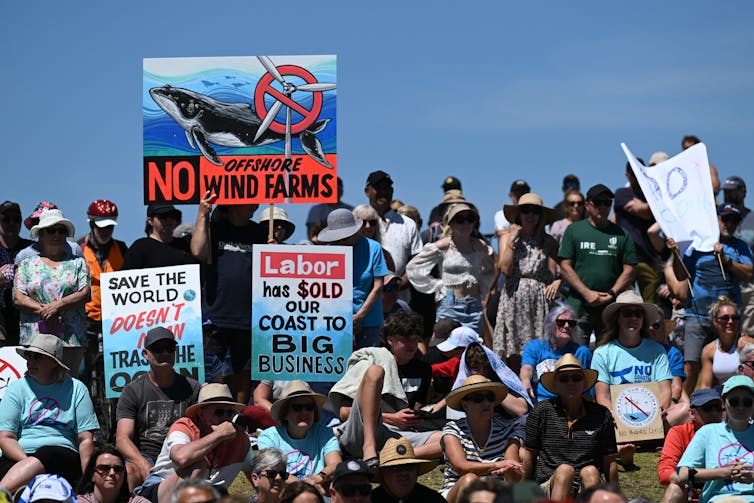 protesters at a rally against offshore wind, people holding signs.