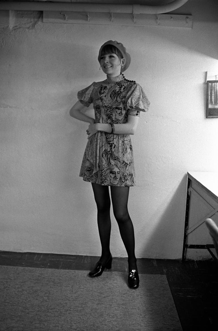 In a mini-dress wearing a beret.