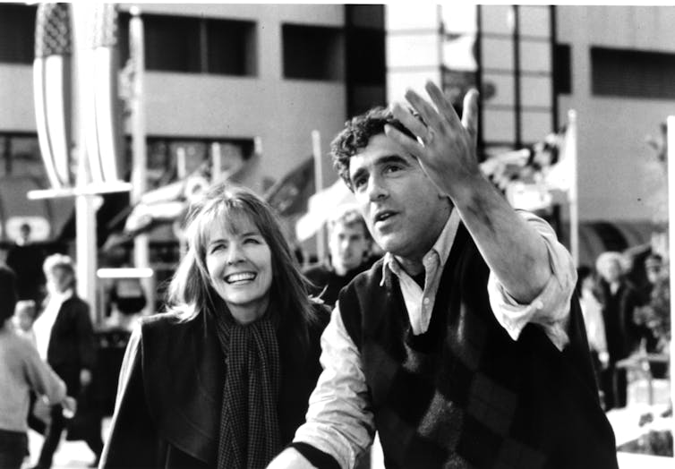 Keaton smiles while Gould gestures.