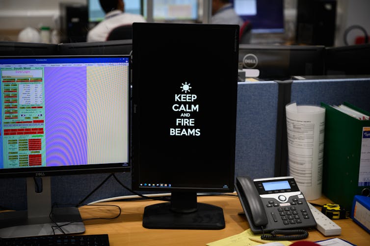 A computer screensaver reading KEEP CALM AND FIRE BEAMS