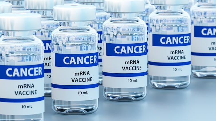 Countless clear vials of liquid with labels reading 'CANCER mRNA vaccine 10 ML' on a table