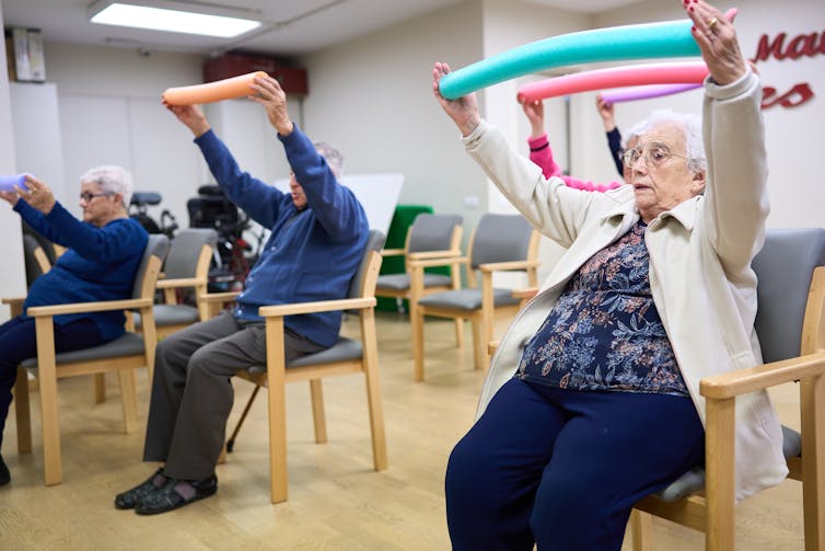 Older residents exercise with a physiotherapist
