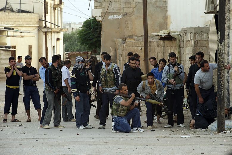 These photos were taken by Austin Tice in Syria in May and June 2012, as he made his way south through the war-torn country. Here, rebel fighters are seen exchanging fire with the Syrian Army forces.