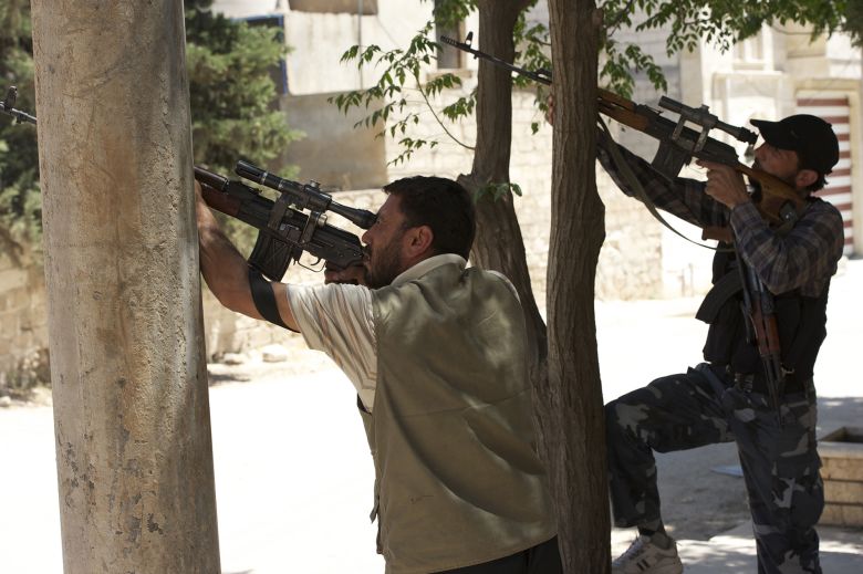 In this image for the Washington Post, Tice captured Free Syrian Army (FSA) fighters using rifles to attempt to shoot down an attack helicopter that was circling overhead.