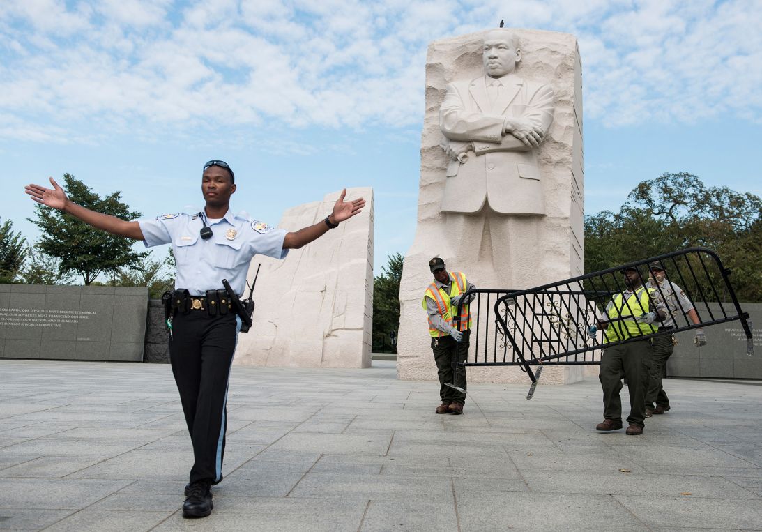 A US Park Police officer and National Park Service employees close the Martin Luther King Jr. Memorial in Washington, DC, during the shutdown in October 2013.