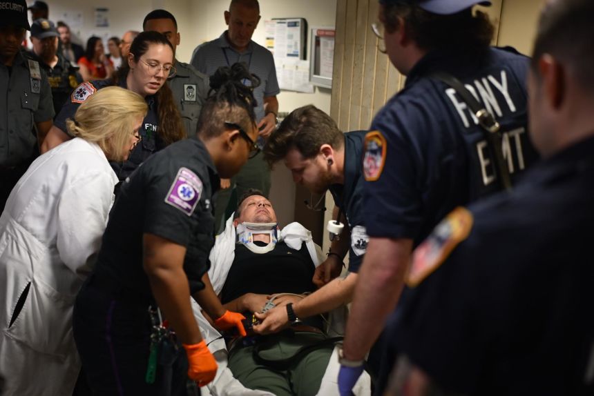 The journalist is seen being hospitalized after falling and hitting his head on the ground in New York City, on Tuesday.