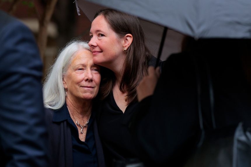 Patrice Failor, wife of former FBI director James Comey, is embraced by her daughter Maurene Comey as they arrive at the US District Court for the Eastern District of Virginia's Bryan Courthouse.