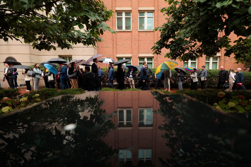 People wait in line to enter the US District Court for the Eastern District of Virginia's Bryan Courthouse in Alexandria, Virginia, on Wednesday.
