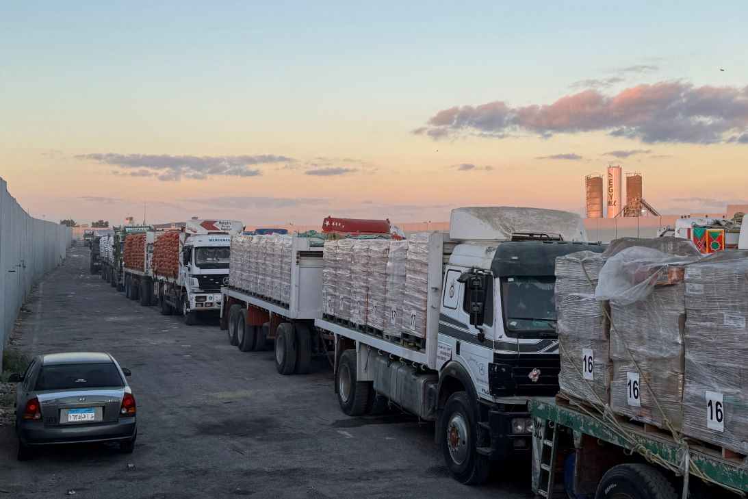 Trucks loaded with humanitarian aid on the Egyptian side of the Rafah crossing wait to cross into Gaza early on Wednesday.