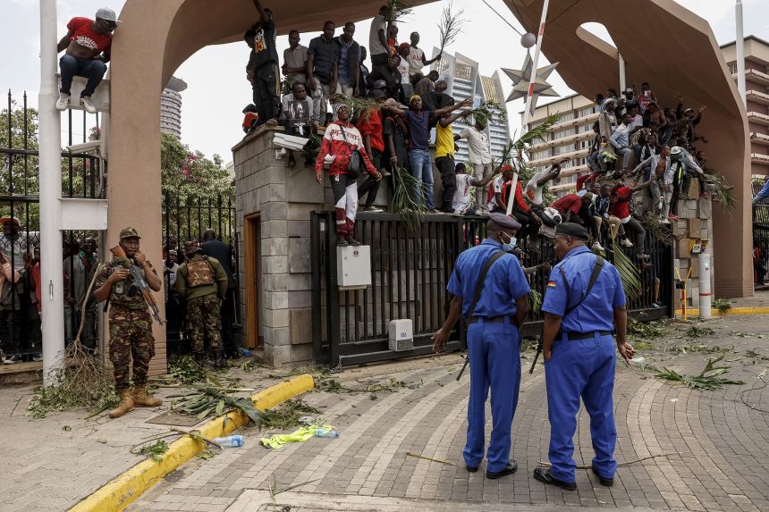 Police officers guarding the Kenya Parliament as Odinga's supporters gather on Thursday.