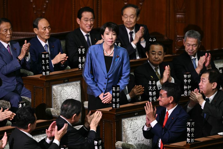 Liberal Democratic Party (LDP) President Sanae Takaichi stands up to acknowledge the applause after she was selected as Japan's new prime minister during an extraordinary session of the lower house of parliament in Tokyo on Tuesday.