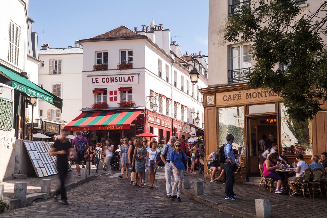 The bustling streets of Paris' Montmartre neighborhood draw crowds of visitors of many nationalities.