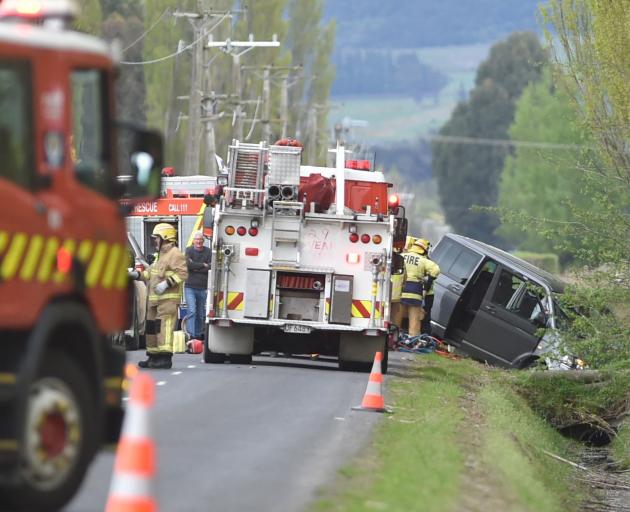 Two people were helped out of the vehicle by firefighters. Photo: Gregor Richardson
