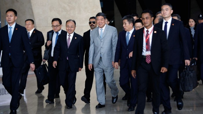He Lifeng, centre, walks with a group of officials and aides, leaving a meeting during US-China trade talks.