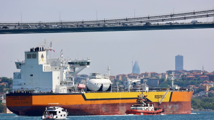 Rosneft’s crude oil tanker Vladimir Monomakh passes under a bridge in Istanbul’s Bosphorus, escorted by smaller vessels.