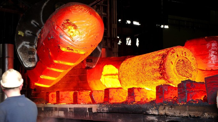 Red hot metal is moved across the heavy forge at the Forgemasters Works in Sheffield, England.