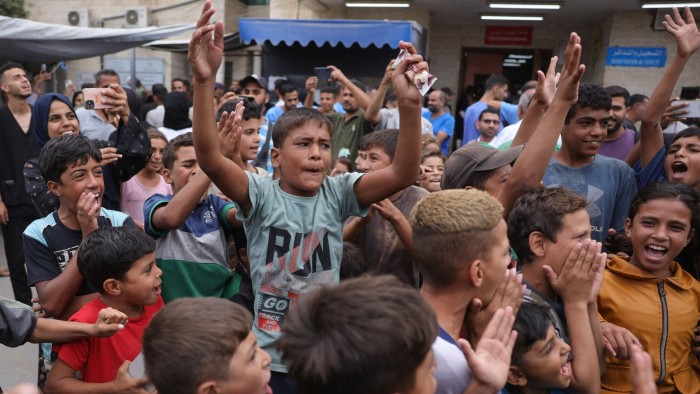 Palestinian children in Gaza celebrate the ceasefire agreement on Thursday