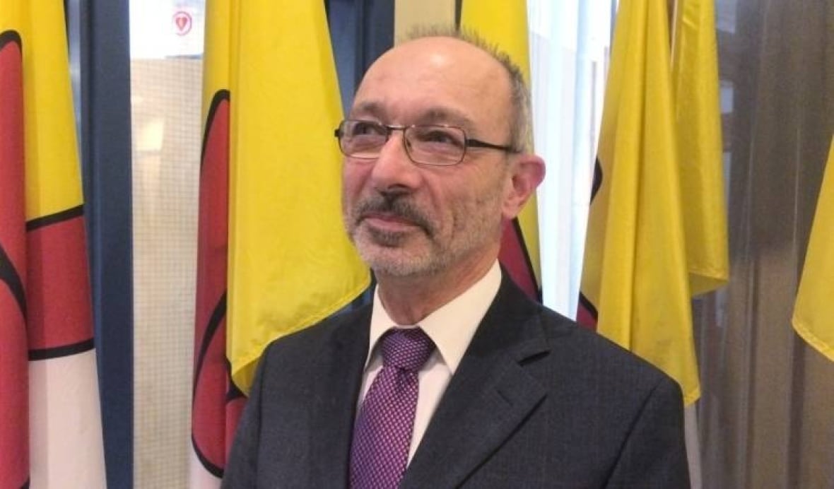 A portrait of a bald man with glasses. 