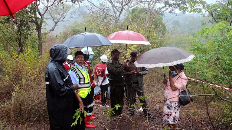 Kenyan officials inspect the scene of a plane crash near Diani, Kenya.