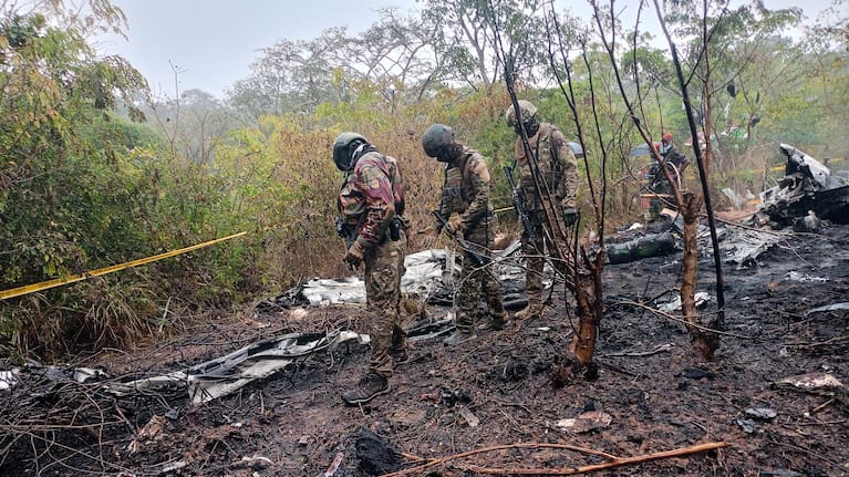 Kenyan officials inspect the scene of a plane crash near Diani, Kenya.