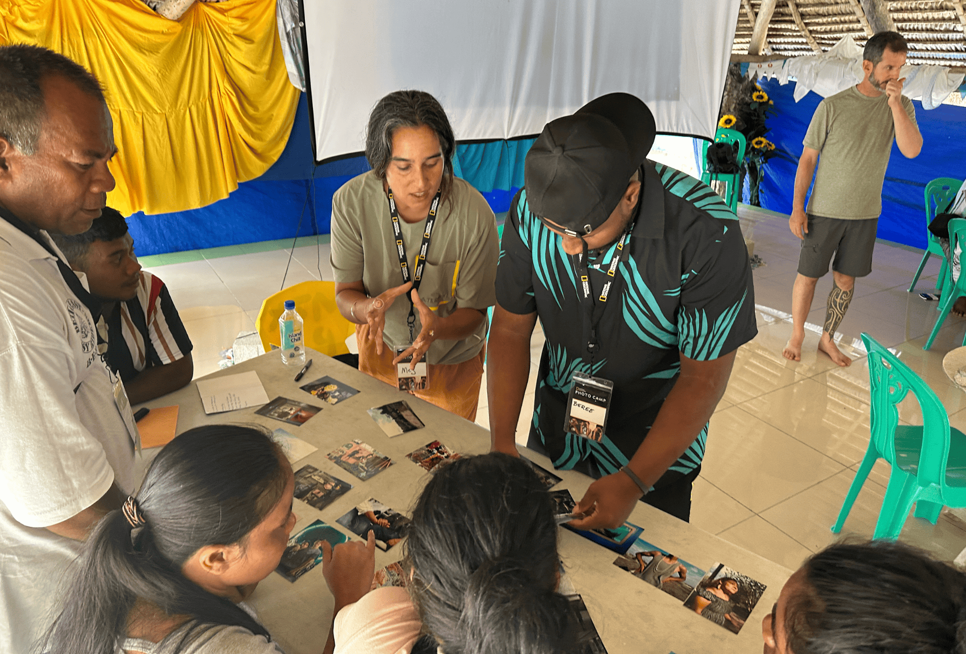 A group of people arranging photos on a table