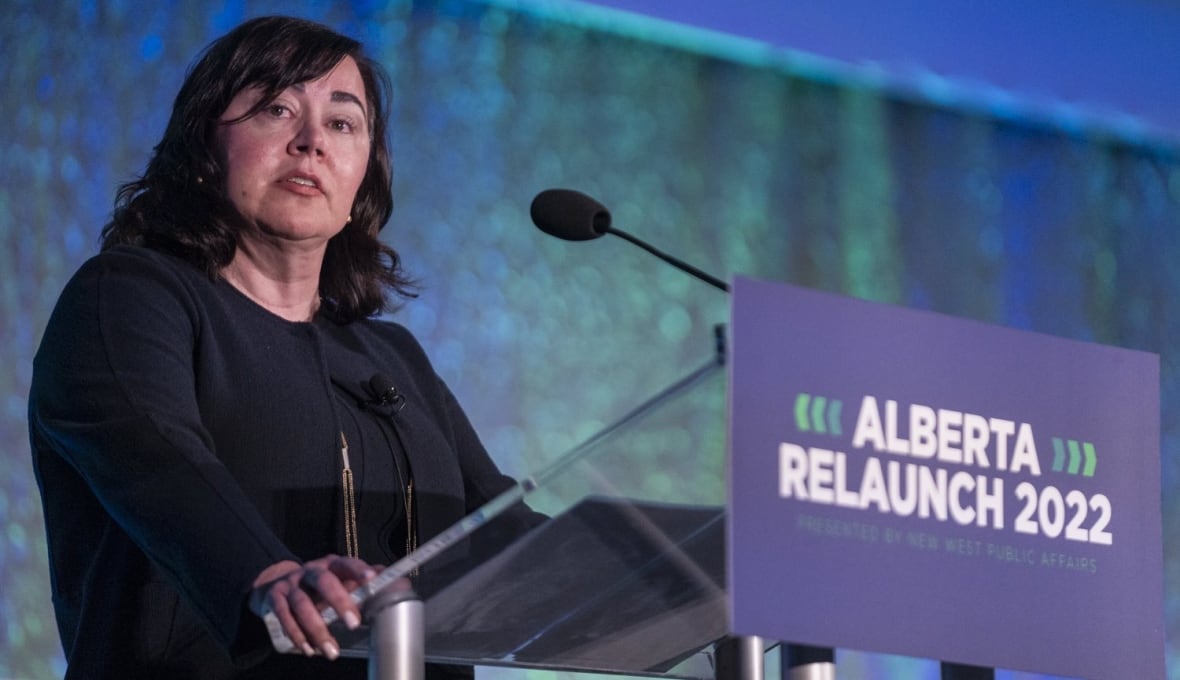 A woman stands at a podium to give a speech.