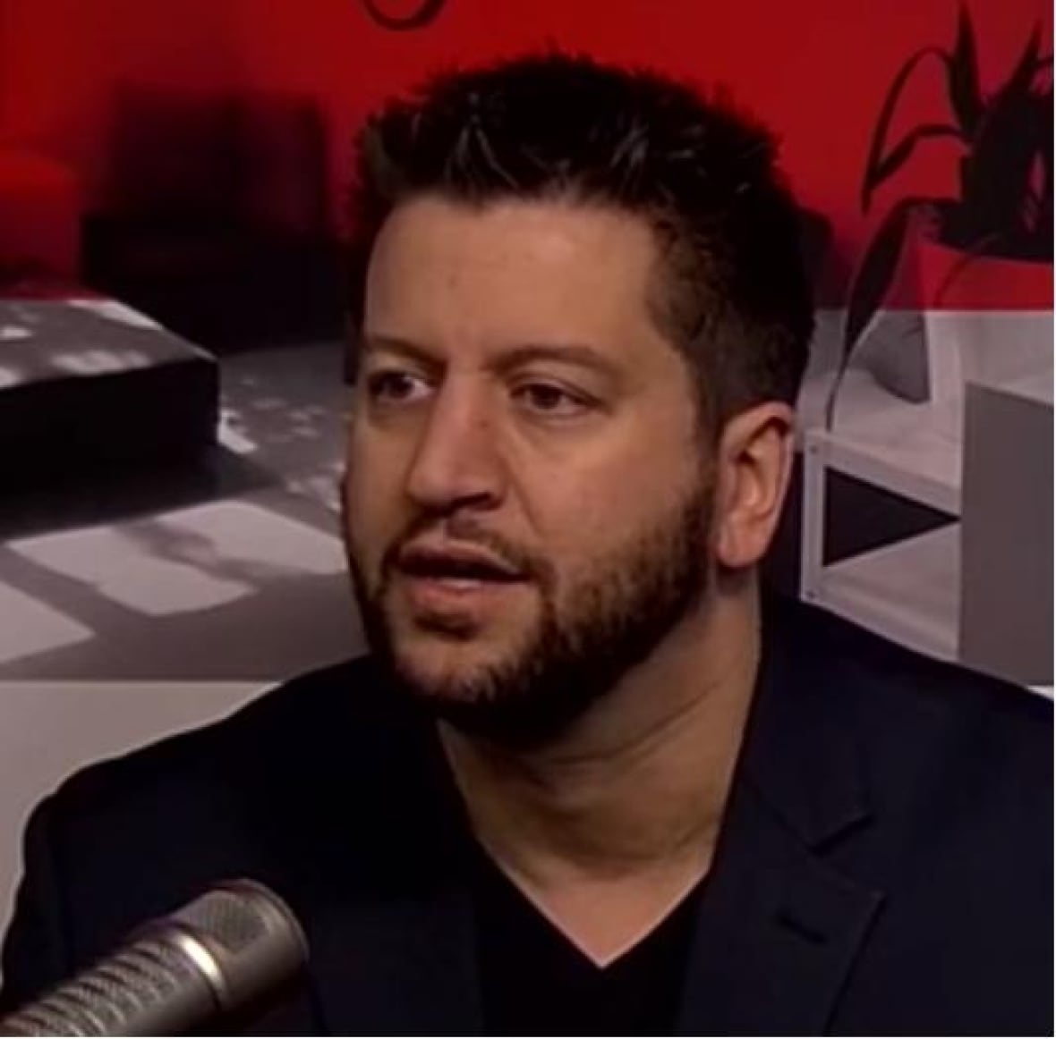 Man speaking into a mic.