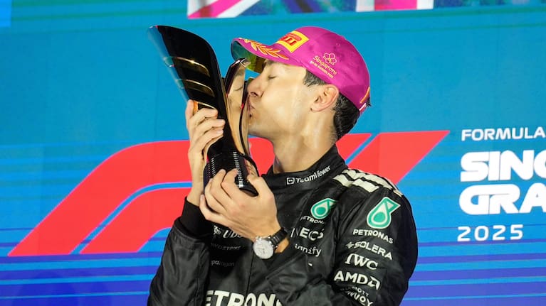 Mercedes driver George Russell of Britain kisses his trophy as he celebrates after winning the Singapore Formula One Grand Prix at the Marina Bay Street Circuit in Singapore.