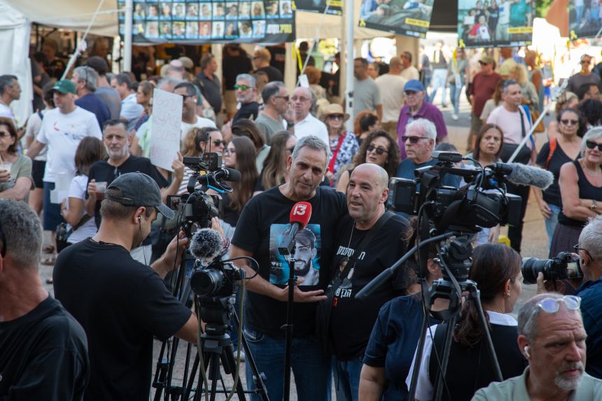 Michel Illouz (left) and Ofir Braslavski, both fathers of hostages, embrace during an interview with local media at Hostages Square in Tel Aviv on Saturday.