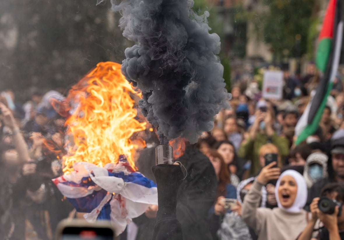 burning flag while people watch